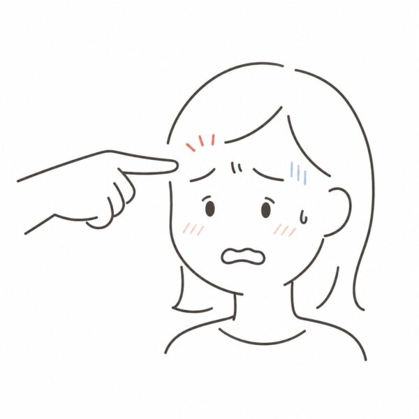 眉間に指を差され不快になっている様子